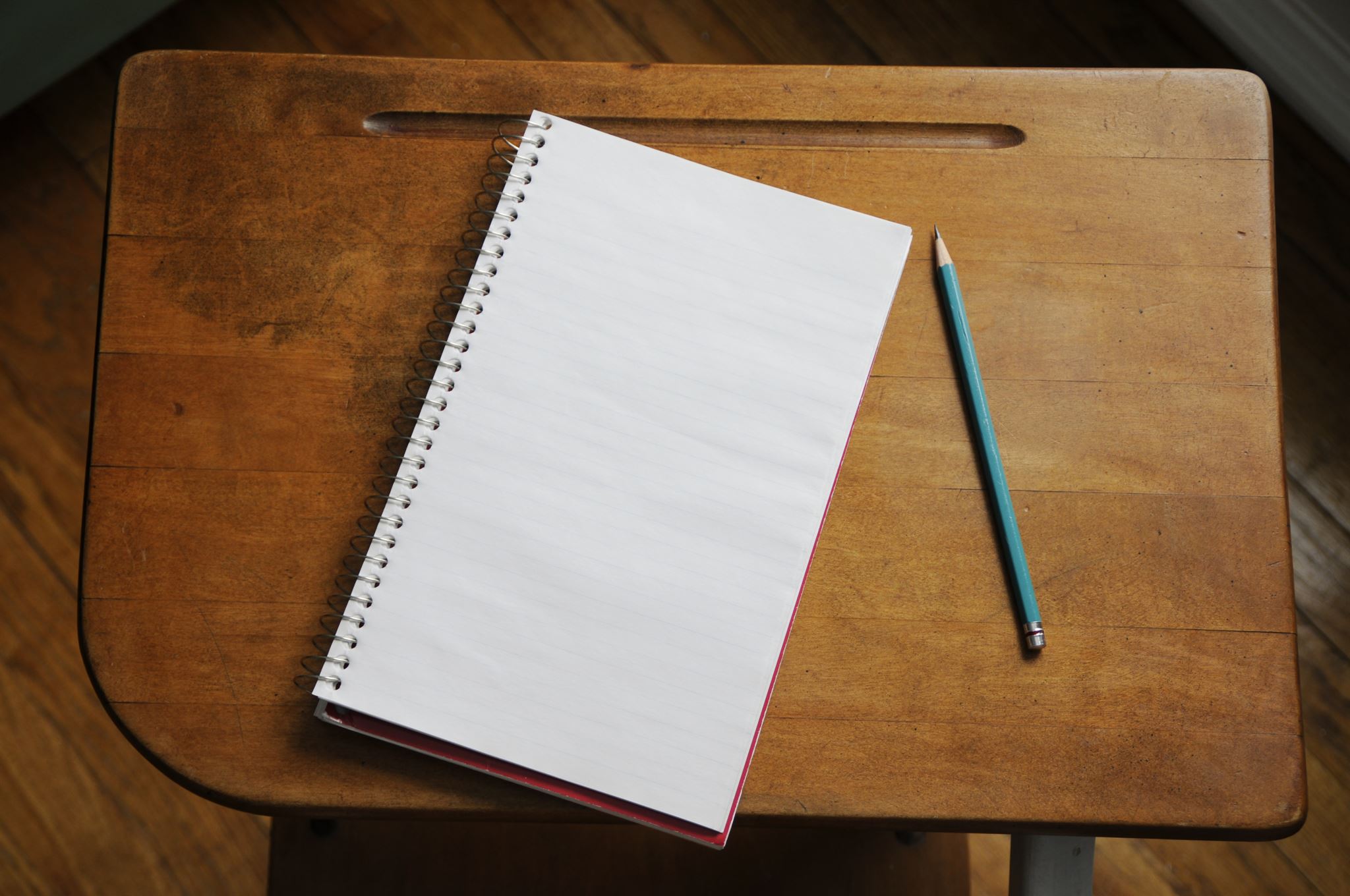 Antique-wood-desk-with-pencil-and-paper
